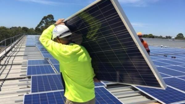 Man carrying a solar panel