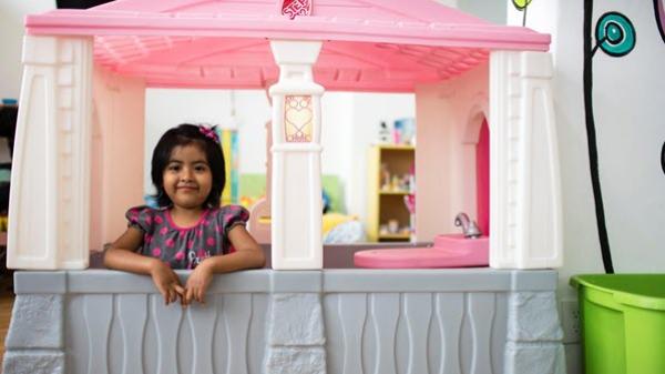 Girl posing inside playhouse